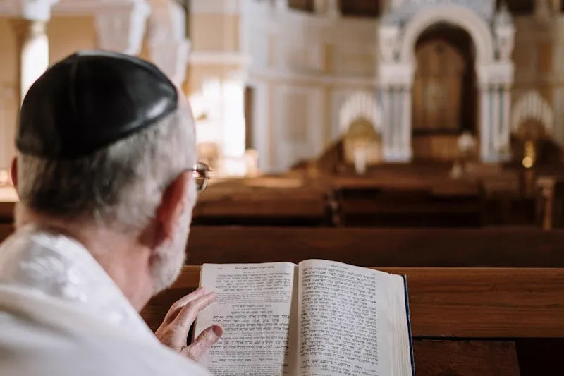 A 3-inch screw being driven through a hinge into the wall stud behind the door jamb